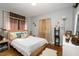 Stylish bedroom with wood floors, a bed with colorful pillows, and decorative accents throughout at 810 Grovemont Rd, Raleigh, NC 27603