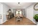 Inviting dining room featuring wood-look tile flooring and a stylish contemporary chandelier at 810 Grovemont Rd, Raleigh, NC 27603