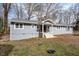 Charming single-story home with gray siding, white trim, and mature trees at 810 Grovemont Rd, Raleigh, NC 27603
