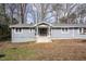 Single-story home featuring gray siding, white trim, and a welcoming front entrance at 810 Grovemont Rd, Raleigh, NC 27603
