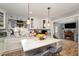 Bright kitchen featuring a center island, white cabinets, and views into the dining area at 810 Grovemont Rd, Raleigh, NC 27603