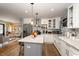 Modern kitchen featuring white cabinets, stainless steel appliances, and a center island at 810 Grovemont Rd, Raleigh, NC 27603