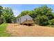 This backyard boasts a cozy, newly constructed wooden deck and lush green surroundings at 810 Williams St, Burlington, NC 27217