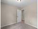 Neutral-toned bedroom featuring plush carpeting and a doorway to another room at 810 Williams St, Burlington, NC 27217