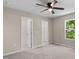 Bedroom featuring a ceiling fan, closet, and natural light from a window at 810 Williams St, Burlington, NC 27217