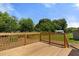 Sunny wooden deck with wooden railings and trees in the background at 810 Williams St, Burlington, NC 27217