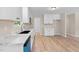 Updated kitchen boasts white cabinets, marble countertops, and modern appliances at 810 Williams St, Burlington, NC 27217