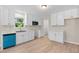 This home features an updated kitchen with modern appliances and white cabinets at 810 Williams St, Burlington, NC 27217