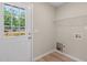 A functional laundry room with a rear entrance and vinyl flooring at 810 Williams St, Burlington, NC 27217