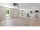 Bright living area with modern wood flooring, white walls, and eat-in kitchen space at 810 Williams St, Burlington, NC 27217