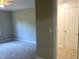 Bright bedroom with neutral carpeting and a pristine white door provides a calm and welcoming atmosphere at 8100 Laurel Mountain Rd, Raleigh, NC 27613