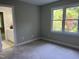 Bedroom featuring carpet, neutral paint, and a large window at 8100 Laurel Mountain Rd, Raleigh, NC 27613