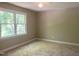 Neutral bedroom with large window allowing natural light at 8100 Laurel Mountain Rd, Raleigh, NC 27613