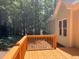 Wooden deck with railing offering outdoor space for relaxation with views of mature trees and natural surroundings at 8100 Laurel Mountain Rd, Raleigh, NC 27613