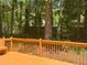 Wooden deck with bench offering a view of the surrounding trees and serene outdoor ambiance at 8100 Laurel Mountain Rd, Raleigh, NC 27613