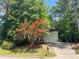 Charming single-Gathering home nestled among mature trees and landscaping at 8100 Laurel Mountain Rd, Raleigh, NC 27613