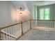 Second floor hallway with railing and pendant light fixture at 8100 Laurel Mountain Rd, Raleigh, NC 27613