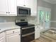 Modern kitchen with stainless steel appliances and a bright, open feel at 8100 Laurel Mountain Rd, Raleigh, NC 27613