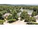 Aerial view of an estate surrounded by lush trees near a picturesque lake under a clear sky at 81002 Alexander, Chapel Hill, NC 27517