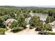 Stunning aerial view of an estate surrounded by lush trees near a picturesque lake under a clear sky at 81002 Alexander, Chapel Hill, NC 27517