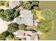 Stunning aerial view of estate home with mature trees and private lake access; perfect for luxurious living at 81002 Alexander, Chapel Hill, NC 27517