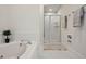Bright bathroom with a soaking tub, walk-in shower with glass doors, and decorative towels at 81002 Alexander, Chapel Hill, NC 27517
