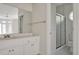 Bright bathroom featuring a white vanity with mirror, a separate shower with glass doors, and a tiled floor at 81002 Alexander, Chapel Hill, NC 27517