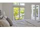 Bright bedroom featuring a window and access to a balcony with natural light and outdoor views at 81002 Alexander, Chapel Hill, NC 27517