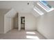 Neutral bedroom featuring a skylight, carpeted floor, and an open doorway to an adjacent bathroom at 81002 Alexander, Chapel Hill, NC 27517