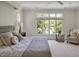 Bright bedroom featuring a ceiling fan, nightstands, and natural light with a lake view at 81002 Alexander, Chapel Hill, NC 27517