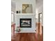 Inviting living room fireplace featuring marble accents, hardwood floors, and decor, set inside a cozy space at 81002 Alexander, Chapel Hill, NC 27517