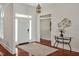 Inviting foyer with light walls, hardwood floors, a modern rug, decor, and a stylish entry door and transom window at 81002 Alexander, Chapel Hill, NC 27517