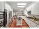 Spacious kitchen with stainless steel appliances, large island, granite countertops, and hardwood floors at 81002 Alexander, Chapel Hill, NC 27517