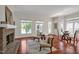 Open living room with hardwood floors, bright sunlight, fireplace, stylish furniture, and outdoor lake view at 81002 Alexander, Chapel Hill, NC 27517