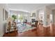 Bright living room with fireplace, hardwood floors, large windows, and stylish furniture including a comfortable sofa at 81002 Alexander, Chapel Hill, NC 27517