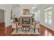Comfortable seating in a stylish living room with a brick fireplace and beautiful hardwood floors at 81002 Alexander, Chapel Hill, NC 27517