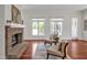 Living room with brick fireplace and large windows providing natural light and views of the outdoors at 81002 Alexander, Chapel Hill, NC 27517