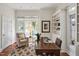 Cozy home office with built-in shelving, a comfortable chair, and natural light from the windows at 81002 Alexander, Chapel Hill, NC 27517