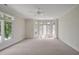 A carpeted room featuring a ceiling fan and large windows at 81002 Alexander, Chapel Hill, NC 27517