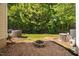Backyard with a fire pit and wooded backdrop creating an ideal setting for relaxation and entertainment at 8422 Central Dr, Raleigh, NC 27613
