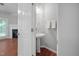 Cozy half-bathroom with hardwood floors, white walls, and pedestal sink at 8422 Central Dr, Raleigh, NC 27613