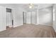 Spacious bedroom with neutral carpet, a ceiling fan, and closet doors at 8422 Central Dr, Raleigh, NC 27613