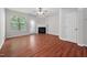 Bright living room with hardwood floors, fireplace, and large windows providing natural light at 8422 Central Dr, Raleigh, NC 27613