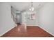 Open-concept living area with hardwood floors, staircase and view to the kitchen at 8422 Central Dr, Raleigh, NC 27613