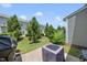 Private backyard patio with barbecue grill, well-maintained landscaping, and grassy areas perfect for entertaining at 8885 Commons Townes Dr, Raleigh, NC 27616