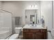 Well-maintained bathroom featuring a shower with glass doors, updated vanity, and fixtures in neutral color palette at 8885 Commons Townes Dr, Raleigh, NC 27616
