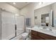 Well-maintained bathroom featuring a shower with glass doors, updated vanity, and fixtures in neutral color palette at 8885 Commons Townes Dr, Raleigh, NC 27616