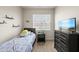 Bright bedroom with a large window, carpeted floors, and neutral paint, perfect for a restful retreat at 8885 Commons Townes Dr, Raleigh, NC 27616