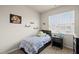 Comfortable bedroom with a large window and plenty of natural light at 8885 Commons Townes Dr, Raleigh, NC 27616