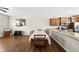 Open dining area featuring wood floors, a table with seating for six, and a kitchen bar at 8885 Commons Townes Dr, Raleigh, NC 27616